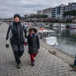 Vula and Anastasia walking by the channel