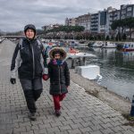 Vula and Anastasia walking by the channel